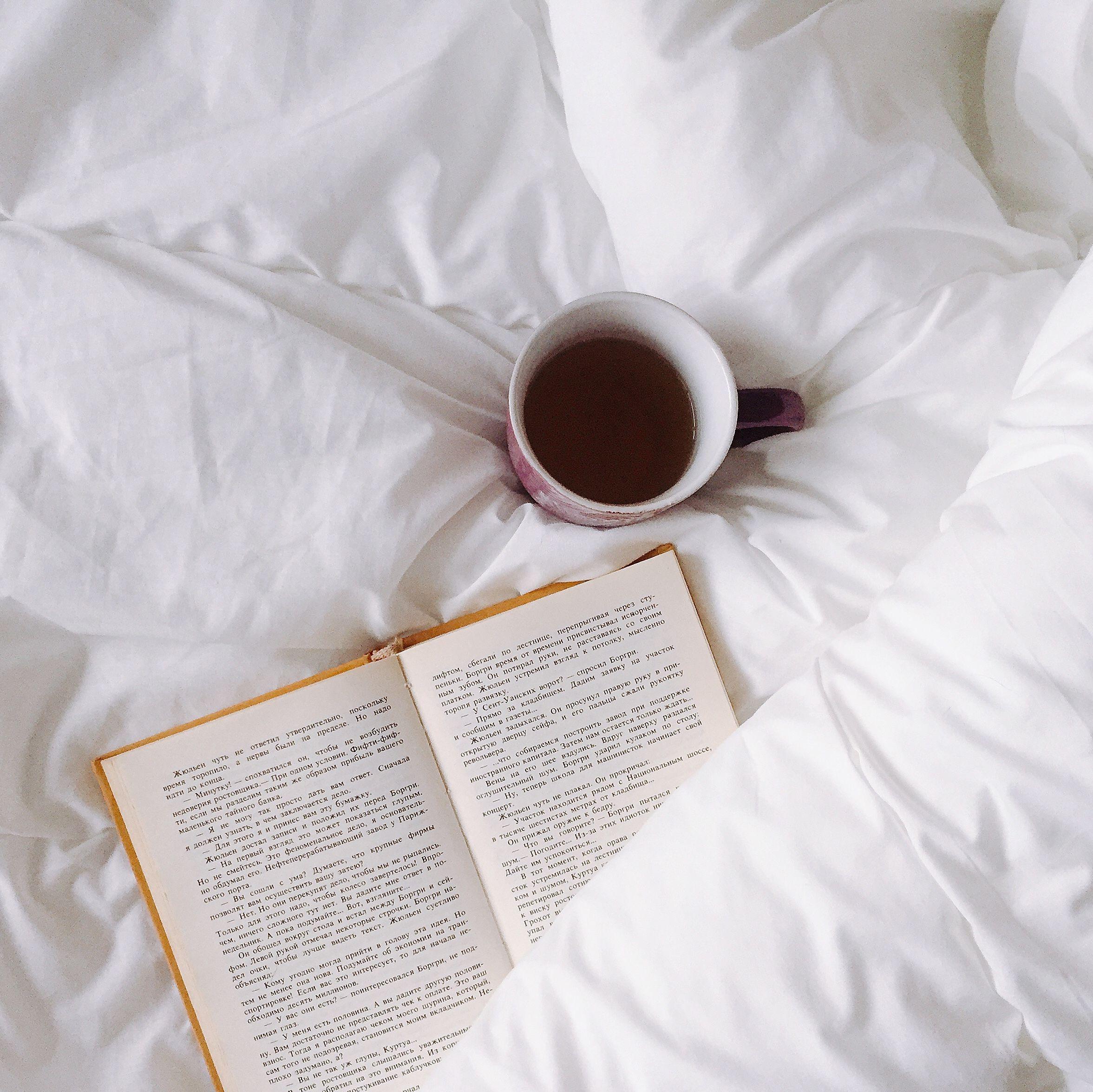 Book and coffee on a bed